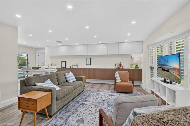 The living room features custom cabinetry up and down for massive storage.