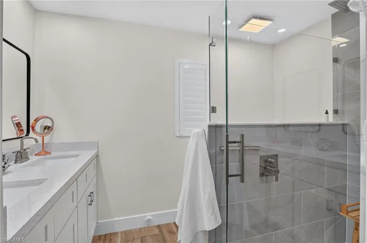 Dual sinks and large walk-in shower in owners suite.
