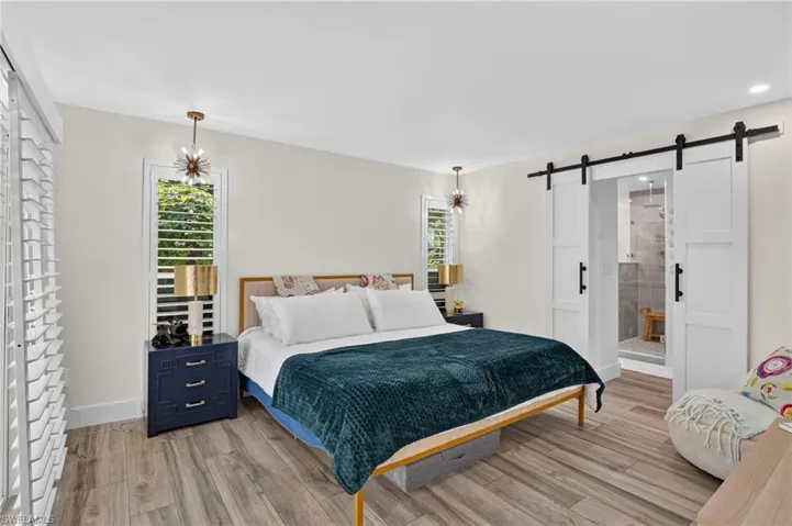 Owners suite with sliding barn doors to bathroom and walk in closet.
