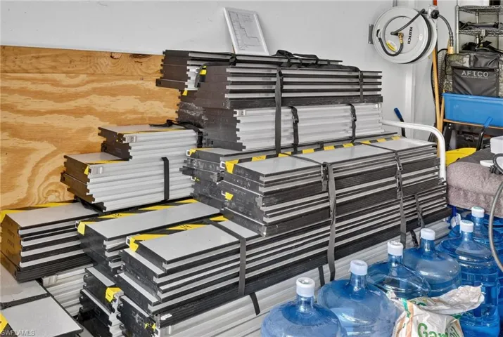 Flood protection system panels in garage, labeled for easy deployment.