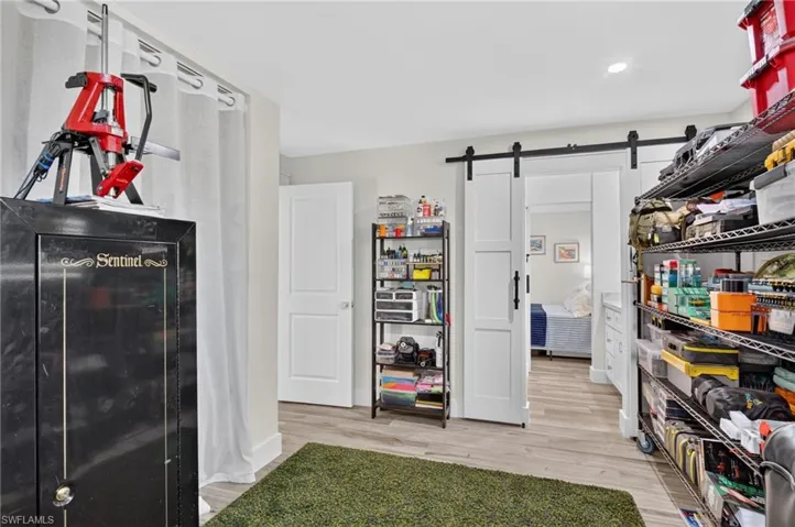 Third bedroom, currently used as storage / office. Barn doors to bathroom.