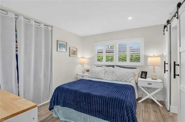 Second bedroom with barn door sliders to bathroom.