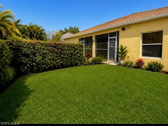 Expansive green lawn with mature hedge landscaping