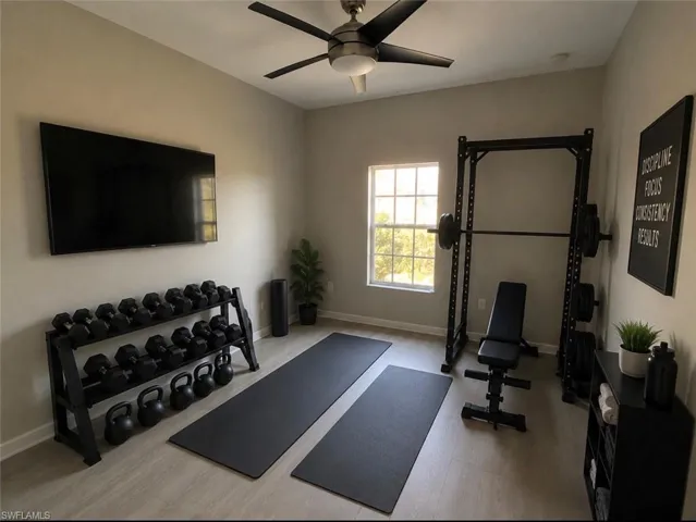 Versatile bonus room featuring light wood-finish flooring, a contemporary ceiling fan, and a double-pane window