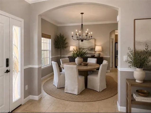 Dining area featuring a black chandelier and a round table