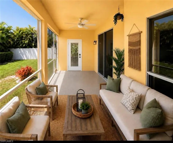 Screened lanai featuring concrete flooring and a ceiling fan