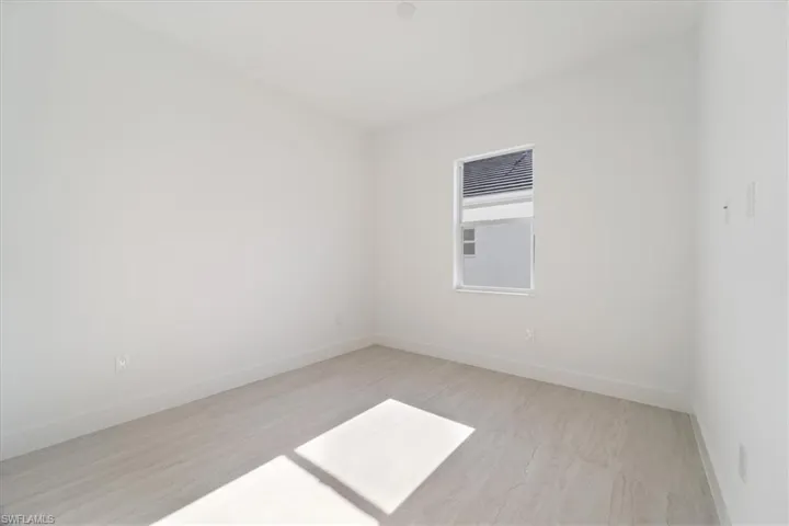 Empty room with light wood-type flooring and baseboards