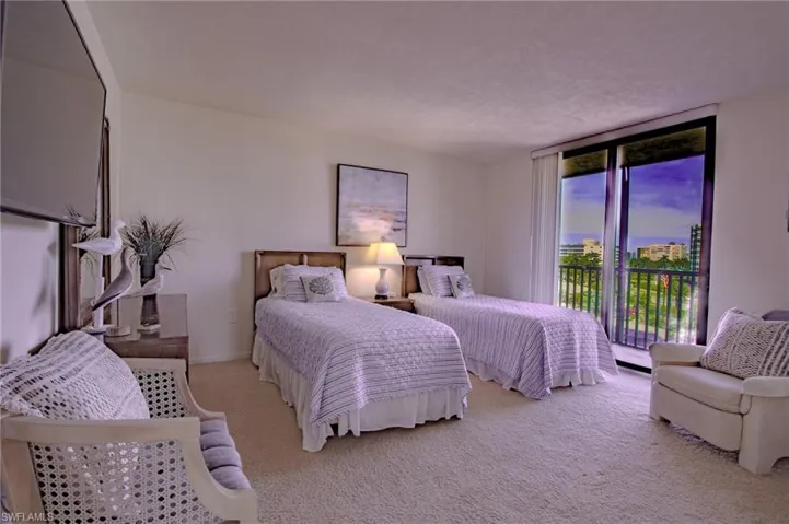 Twin bedroom with patio.  Bright and cheerful bedrooms ready to welcome guests.