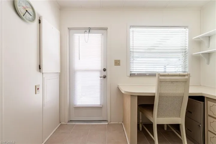 Unfurnished office with light tile patterned floors and crown molding