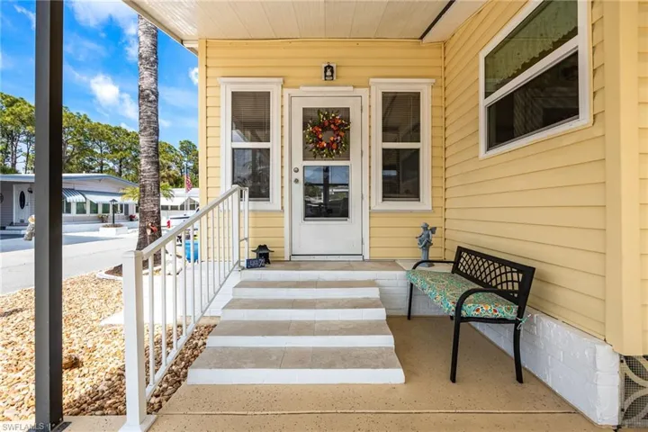 Doorway to property featuring covered porch