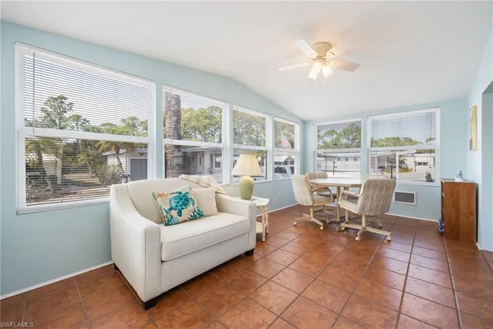 Sunroom / solarium featuring vaulted ceiling and tile patterned flooring