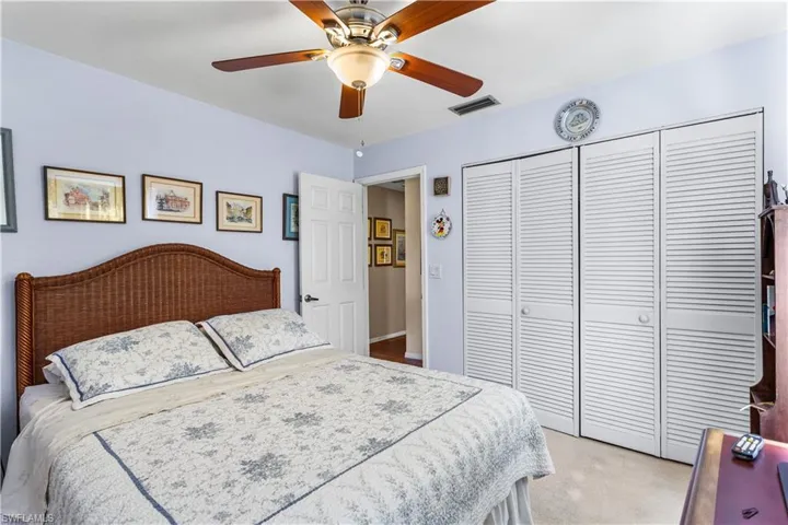 Bedroom with carpet flooring, a closet, and ceiling fan