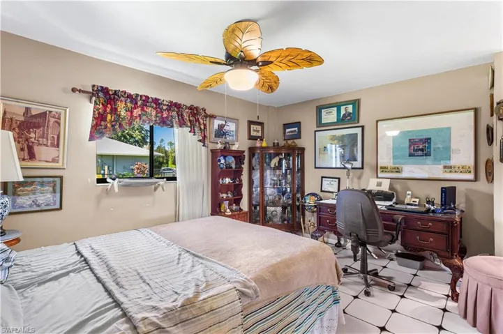 Bedroom with ceiling fan and tile flooring
