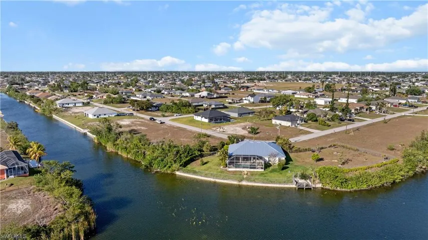 Birds eye view of property with a residential view and a water view