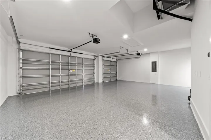 Garage with electric panel and a garage door opener