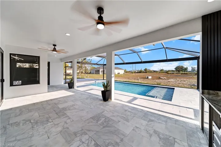 Pool featuring a ceiling fan, a lanai, and a patio area