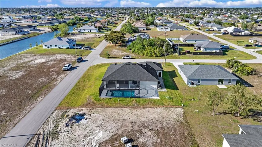 Drone / aerial view with a water view and a residential view