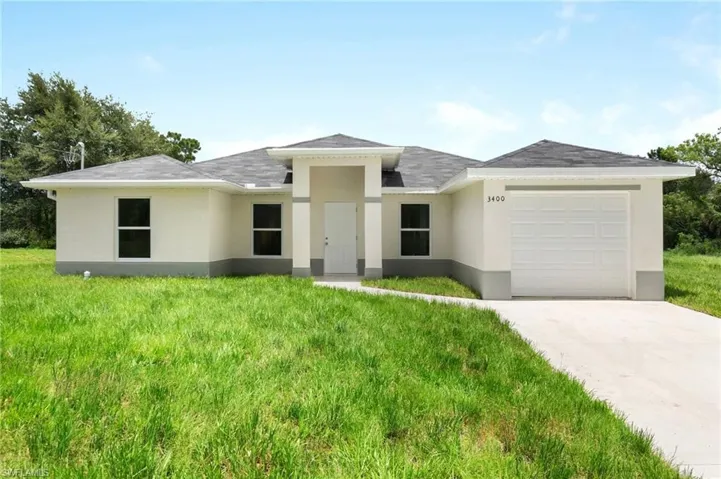 Prairie-style house with a garage and a front yard