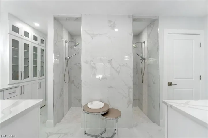 Custom cabinetry, large walk-in shower, separate toilet room with bidet, his and her sinks.