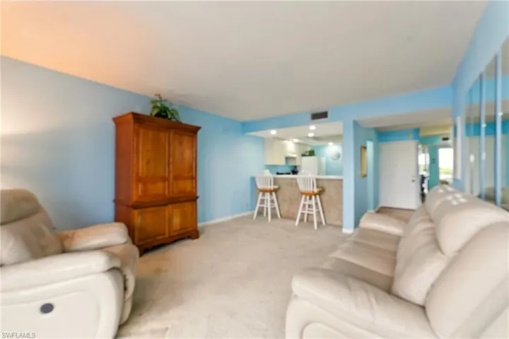 Carpeted living room with baseboards