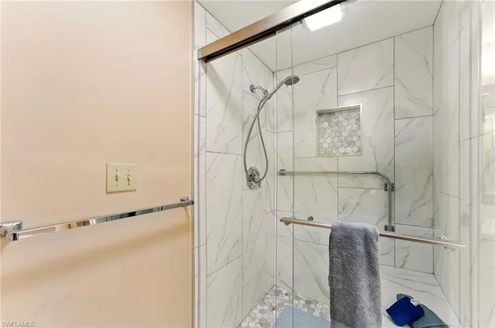 Bathroom featuring a marble finish shower