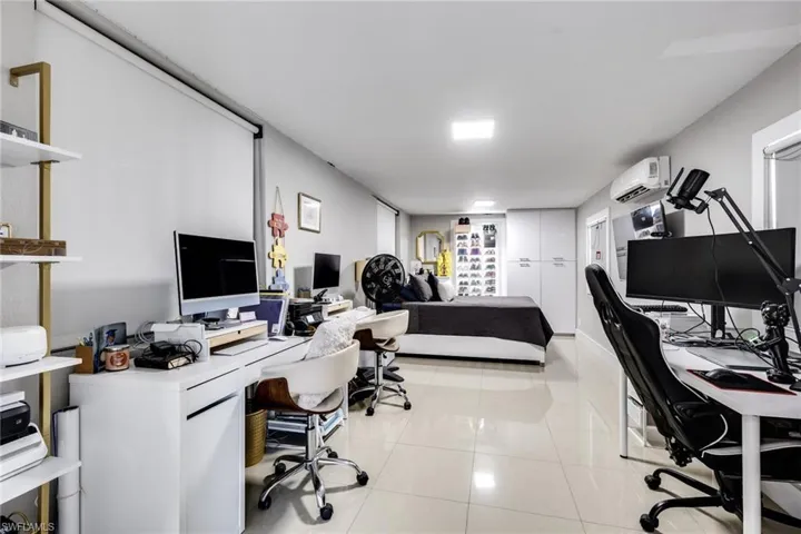 Office area with a wall mounted AC and light tile patterned floors