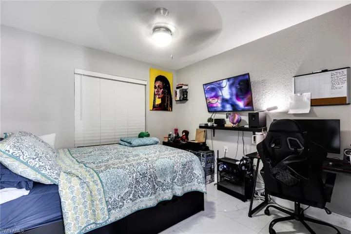 Bedroom with marble finish floor and ceiling fan