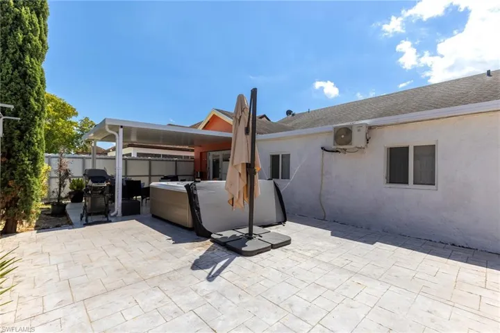 View of patio / terrace featuring ac unit, a hot tub, and a fenced backyard
