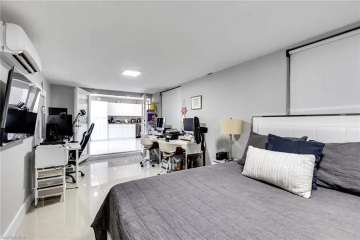 Bedroom featuring a wall mounted AC and light tile patterned floors