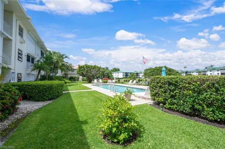 Community pool featuring a lawn and a patio