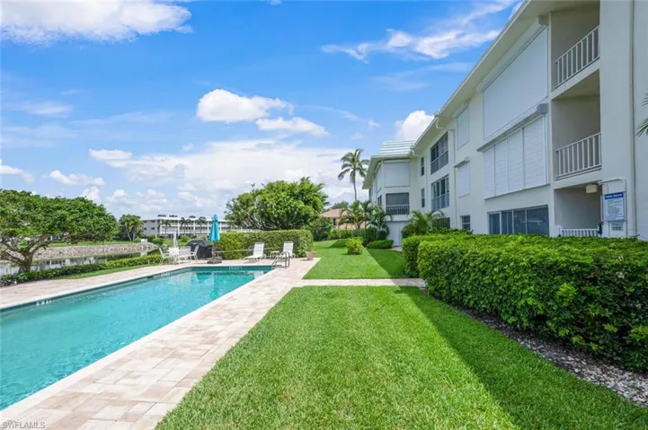 Community pool featuring a yard and a patio
