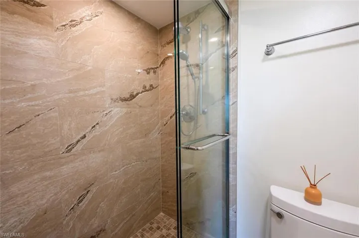 Bathroom featuring a stall shower and toilet