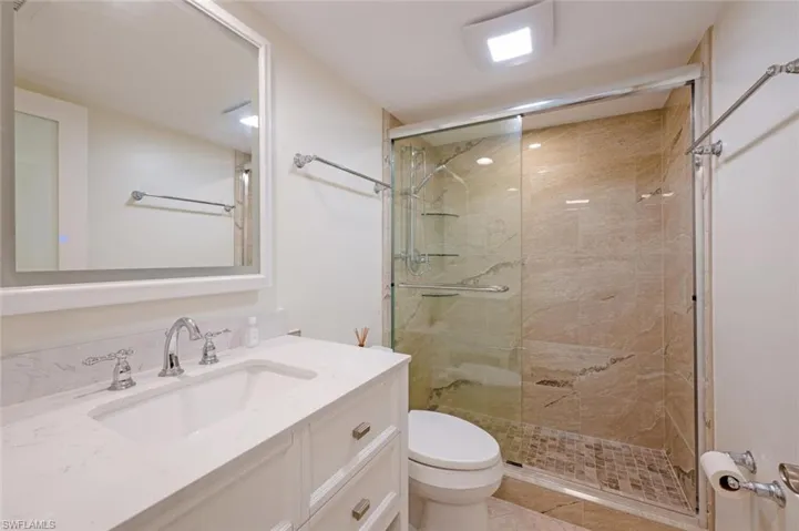 Bathroom featuring vanity and a shower stall