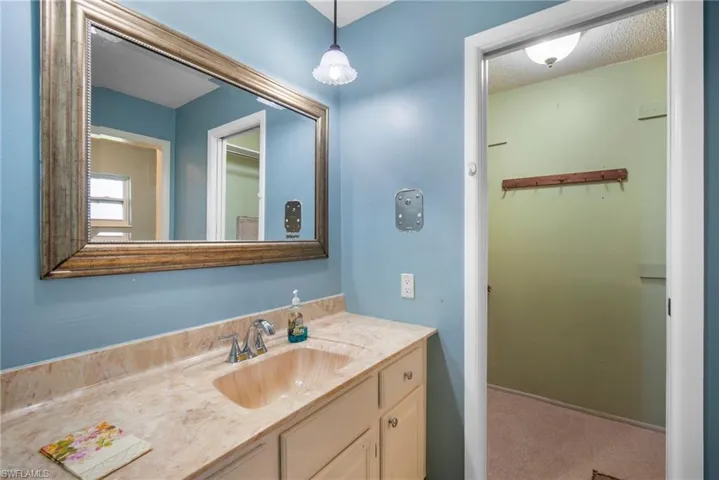 Bathroom featuring vanity and a textured ceiling