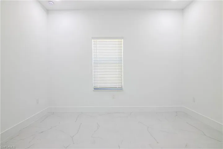 Empty room with recessed lighting and light marble finish flooring