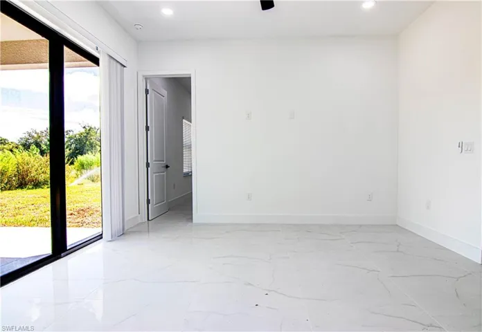 Spare room featuring recessed lighting and light marble finish flooring