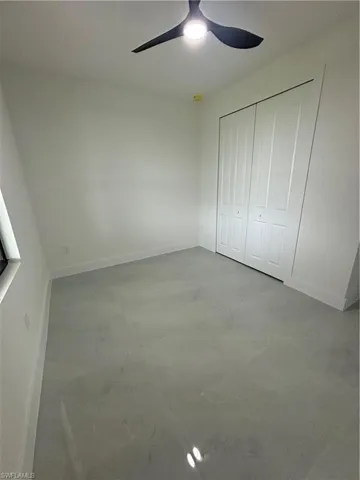 Unfurnished bedroom featuring a closet and ceiling fan
