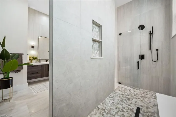 Full bath featuring vanity and a tile shower