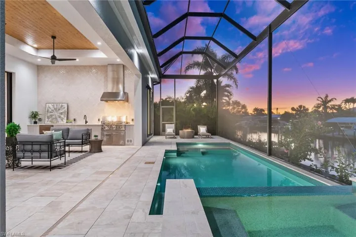 View of swimming pool with outdoor lounge area, a lanai, a patio, and area for grilling
