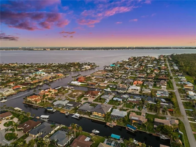 Aerial view at dusk with a residential view and a water view