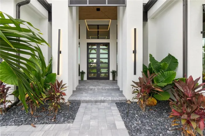 Doorway to property with french doors and stucco siding