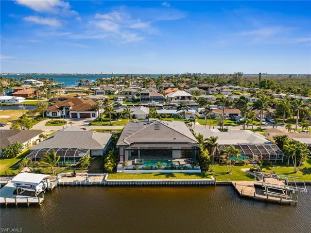 Drone / aerial view with a water view and a residential view