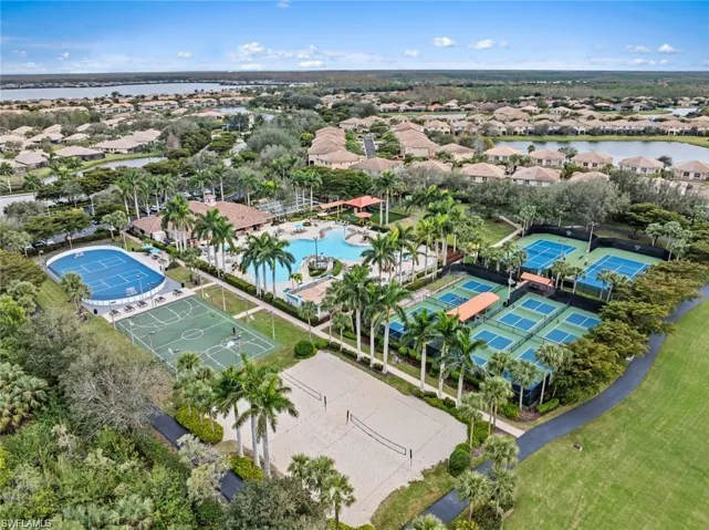 Aerial view of residential area featuring a nearby body of water