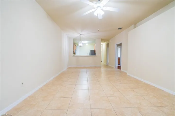 Spare room with light tile patterned floors and a ceiling fan