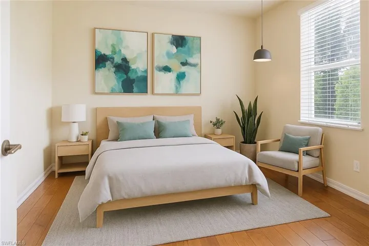 Bedroom featuring hardwood / wood-style floors and baseboards