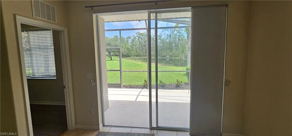 Doorway featuring baseboards and view of scattered trees