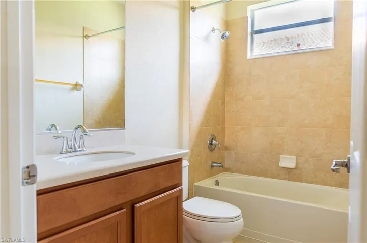 Full bathroom featuring toilet, vanity, and shower / bathtub combination