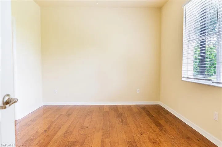 Spare room with light wood-style floors and baseboards