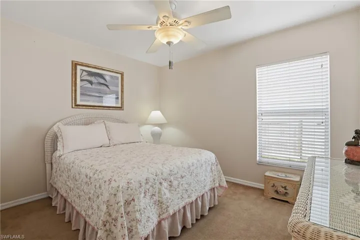 Bedroom with light carpet and ceiling fan