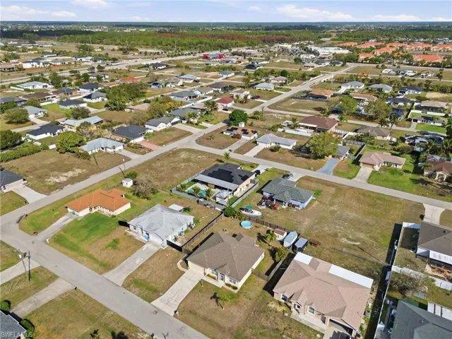 Aerial overview of property's location with nearby suburban area
